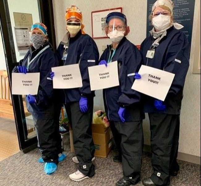 AMITA Health workers with thank you signs