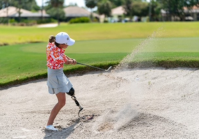 Adaptive Golfer Kelsey Koch gets up and down out of a bunker.
